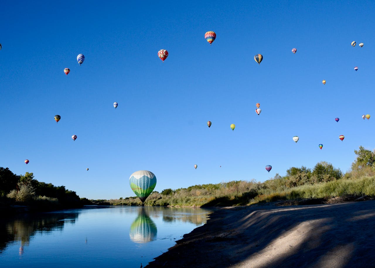 Balloon Landing in the River and a Swarm of Hot Air Balloons in the Sky Above