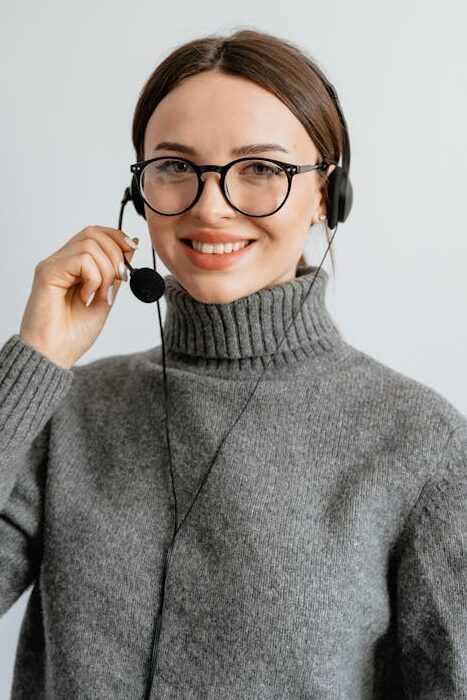 Woman in Gray Turtle Neck Shirt with Black Headset and Mouthpiece